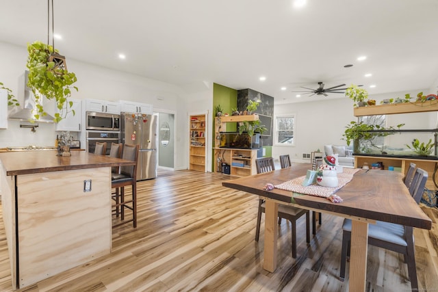 dining area featuring ceiling fan and light wood-type flooring