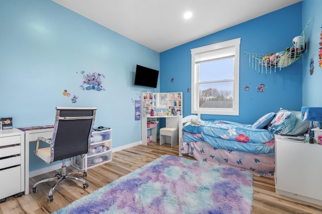 bedroom featuring light hardwood / wood-style floors and lofted ceiling