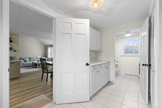 kitchen featuring white cabinets, a baseboard radiator, and light hardwood / wood-style flooring