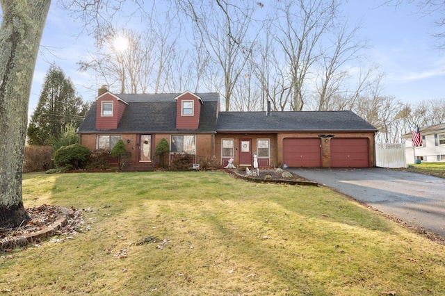 new england style home with a front yard and a garage