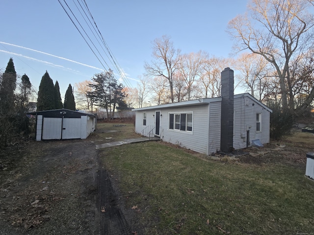 exterior space with a storage unit and a lawn