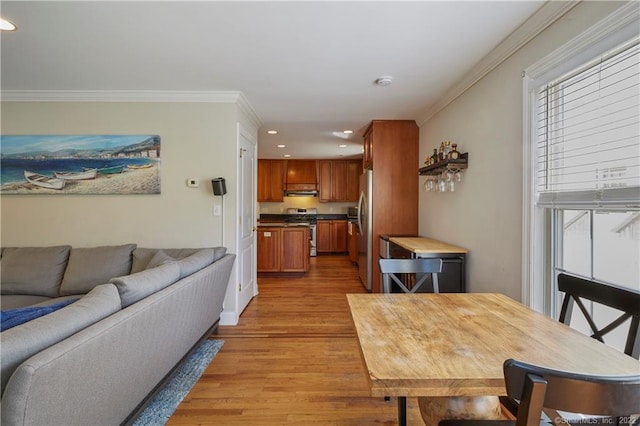 dining area featuring light hardwood / wood-style floors and ornamental molding