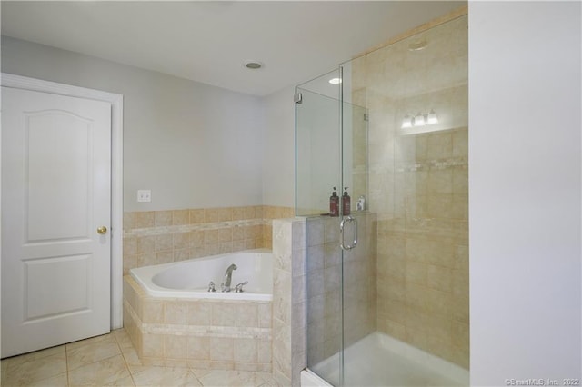 bathroom featuring tile patterned flooring and shower with separate bathtub