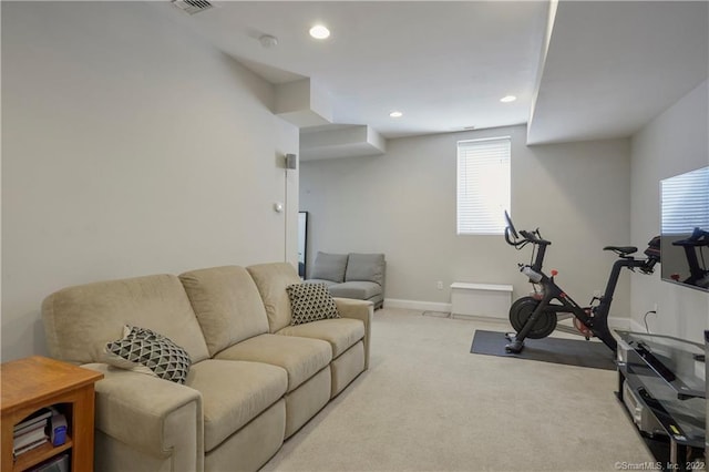 workout room featuring light carpet