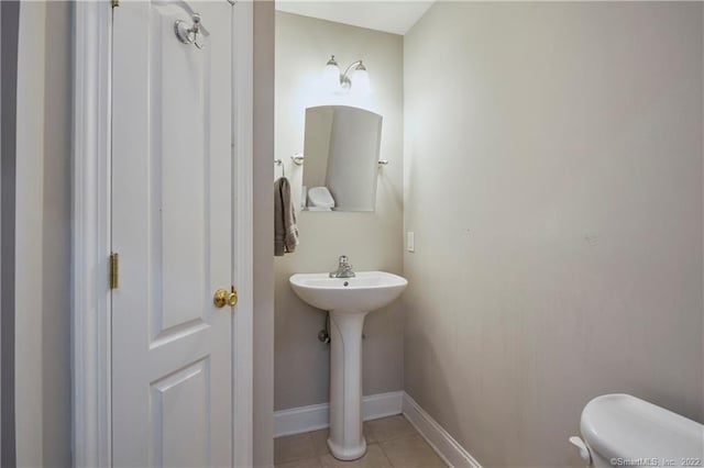 bathroom featuring tile patterned flooring and toilet