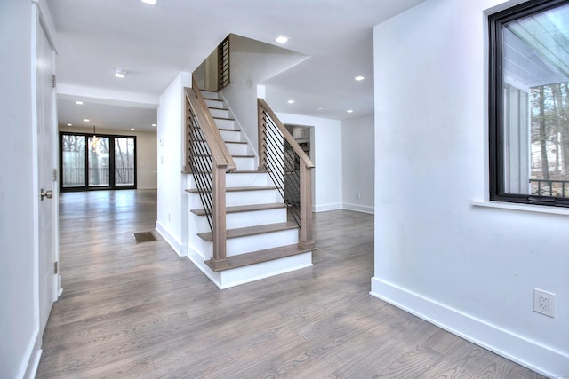 stairs featuring hardwood / wood-style floors