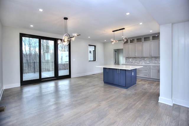 kitchen featuring decorative light fixtures, a center island, and a notable chandelier