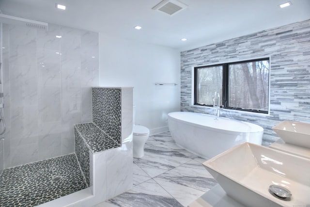 bathroom with independent shower and bath, double sink, tile walls, and toilet