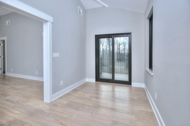 entryway featuring vaulted ceiling and light hardwood / wood-style floors