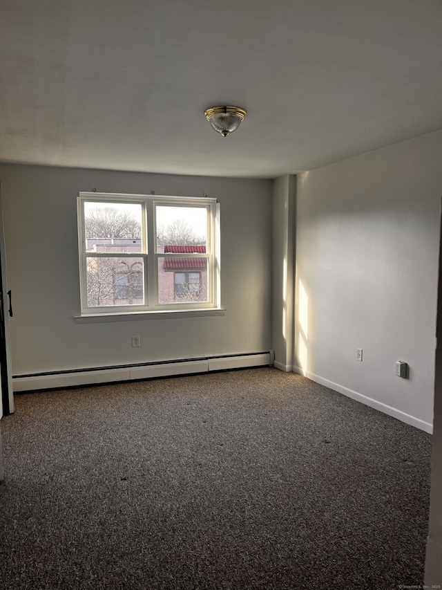 empty room featuring carpet flooring and a baseboard radiator