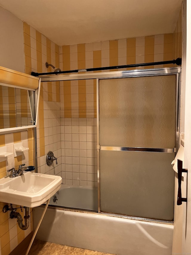 bathroom with combined bath / shower with glass door and sink