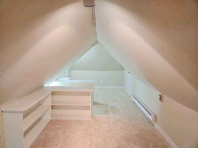 additional living space featuring light colored carpet, lofted ceiling, and a baseboard radiator