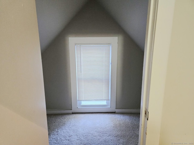 bonus room with carpet and vaulted ceiling