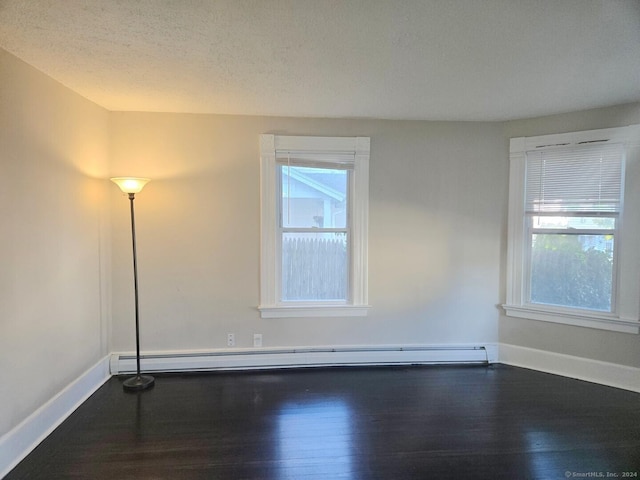 unfurnished room featuring a textured ceiling, a baseboard radiator, and dark hardwood / wood-style floors