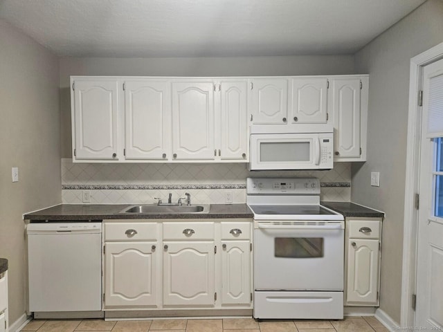 kitchen featuring white cabinetry, sink, light tile patterned floors, and white appliances