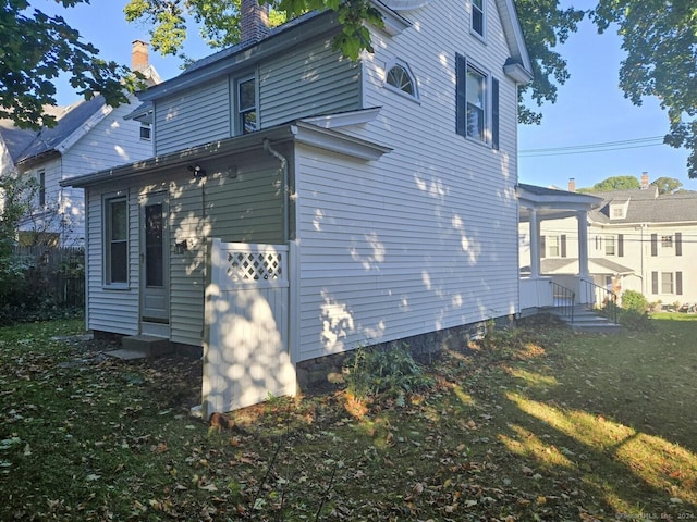 view of home's exterior with a yard