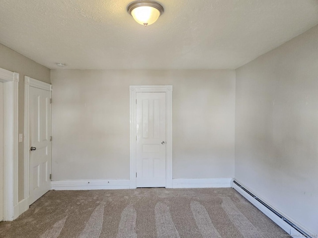 empty room with carpet floors, a baseboard radiator, and a textured ceiling