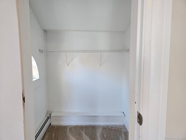 walk in closet with carpet flooring and a baseboard heating unit