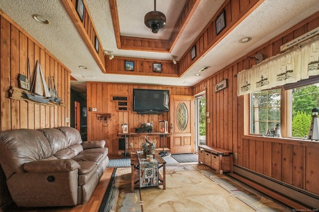 72 Providence Ave, Shelton, CT 06484 - living room featuring a baseboard radiator, plenty of natural light, wooden walls, and a raised ceiling