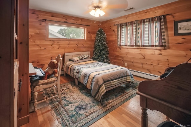 72 Providence Ave, Shelton, CT 06484 - bedroom with a baseboard radiator, wood walls, multiple windows, and wood finished floors