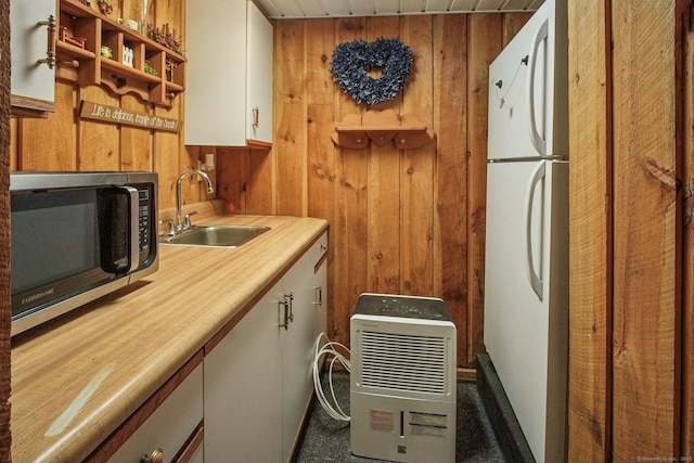 72 Providence Ave, Shelton, CT 06484 - kitchen with stainless steel microwave, freestanding refrigerator, wooden walls, carpet flooring, and open shelves