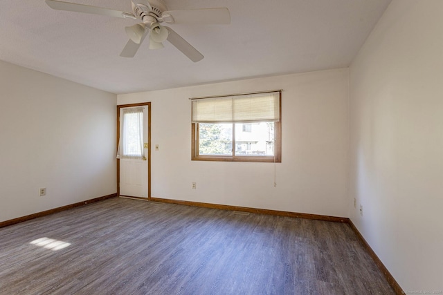 unfurnished room featuring dark hardwood / wood-style floors and ceiling fan