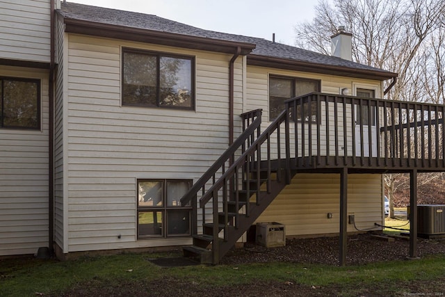 back of house with a wooden deck and central AC unit