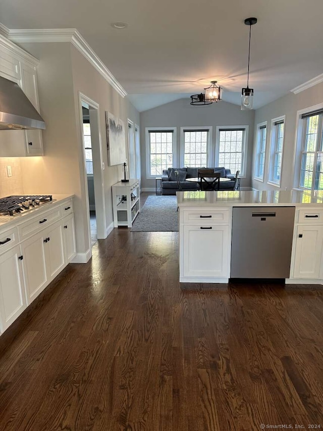 kitchen featuring stainless steel appliances, dark hardwood / wood-style floors, crown molding, vaulted ceiling, and white cabinets