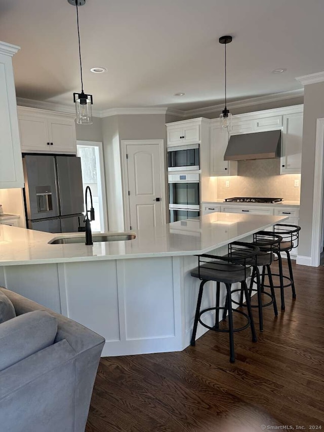 kitchen with sink, white cabinets, pendant lighting, and appliances with stainless steel finishes