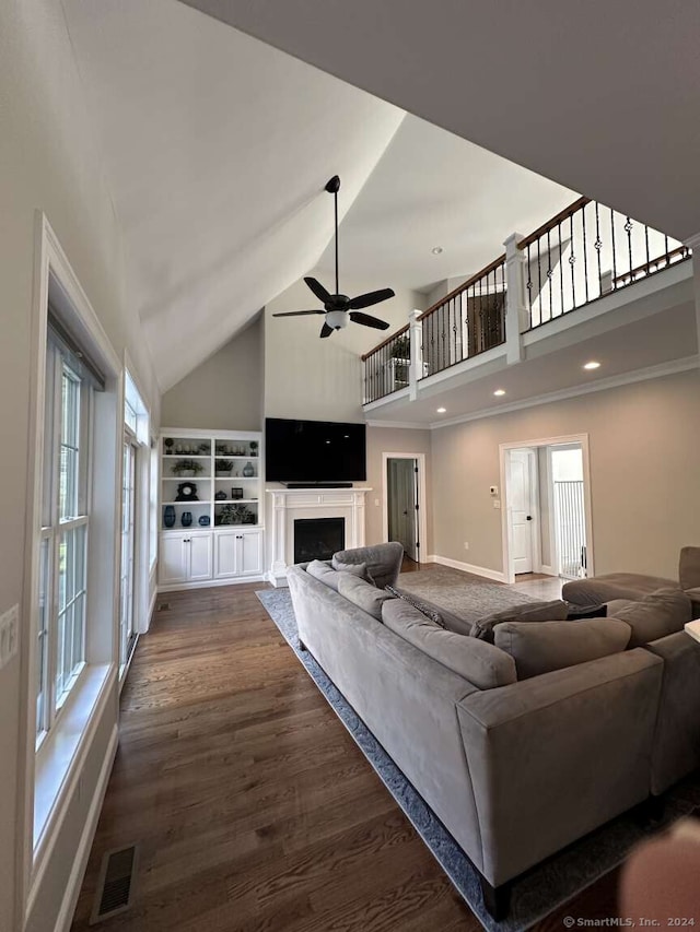 unfurnished living room featuring dark hardwood / wood-style floors, high vaulted ceiling, and ceiling fan