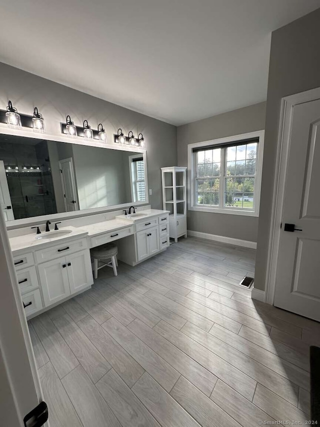 bathroom featuring vanity, an enclosed shower, and hardwood / wood-style flooring