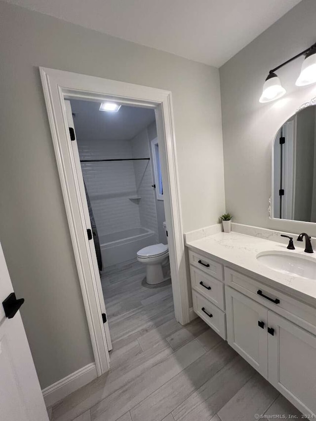 full bathroom featuring shower / tub combination, toilet, vanity, and hardwood / wood-style flooring