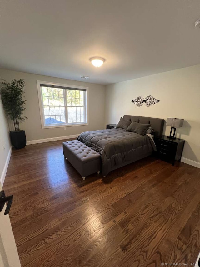 bedroom featuring dark hardwood / wood-style flooring