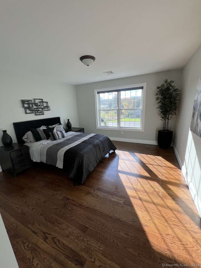 bedroom with hardwood / wood-style floors