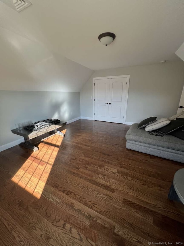 bonus room with dark hardwood / wood-style flooring and lofted ceiling