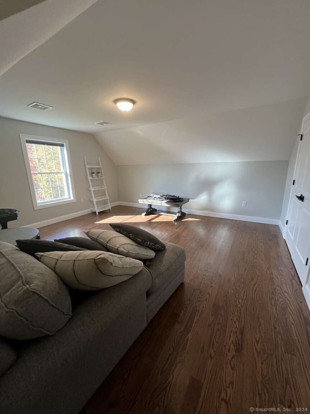 living room with dark hardwood / wood-style flooring and lofted ceiling