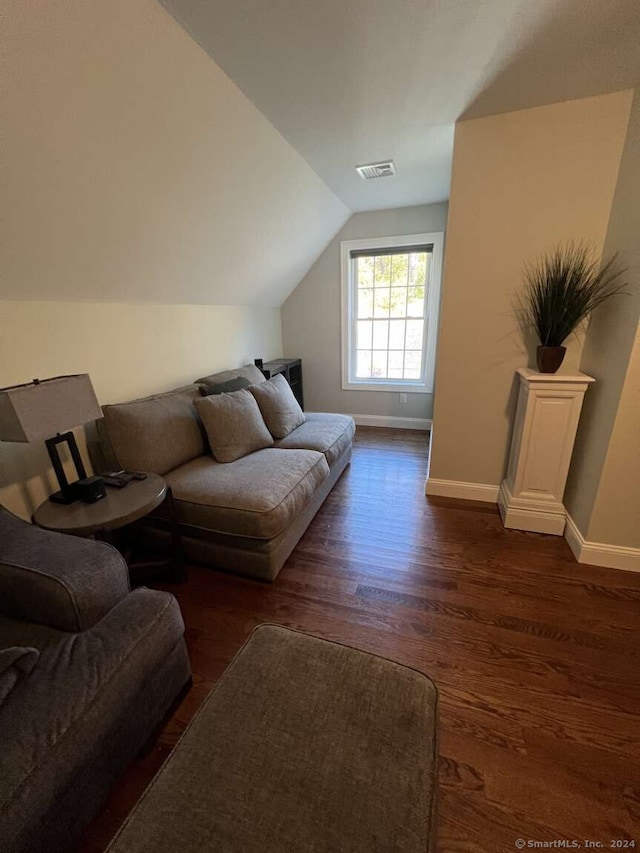 living room with lofted ceiling and dark wood-type flooring