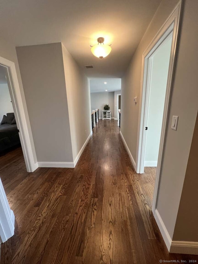 hallway with dark wood-type flooring