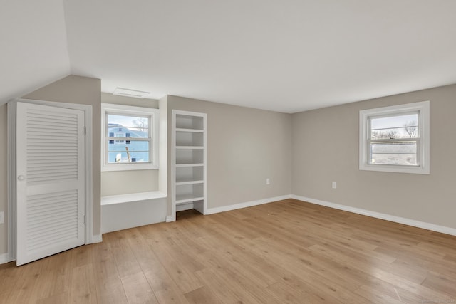 unfurnished bedroom with light hardwood / wood-style flooring and multiple windows