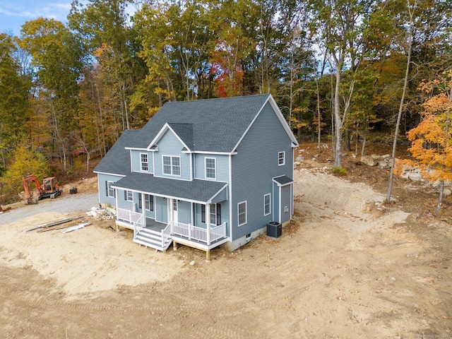 view of front of home with a porch and central air condition unit