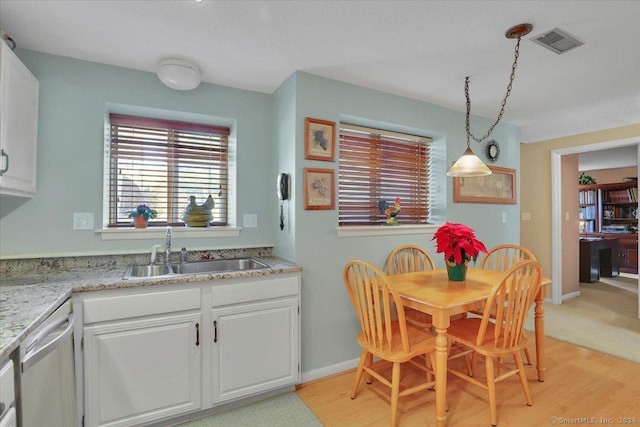 dining space featuring sink and light wood-type flooring