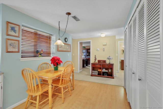 dining space with hardwood / wood-style floors