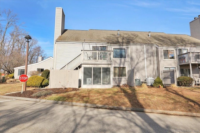 rear view of property with cooling unit