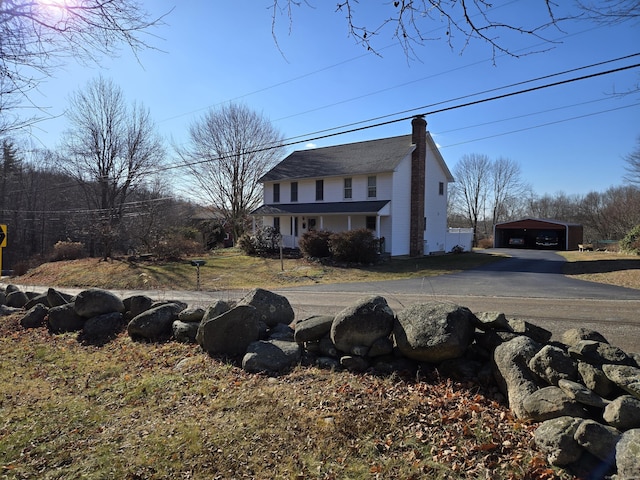 view of front of property with a garage and an outdoor structure