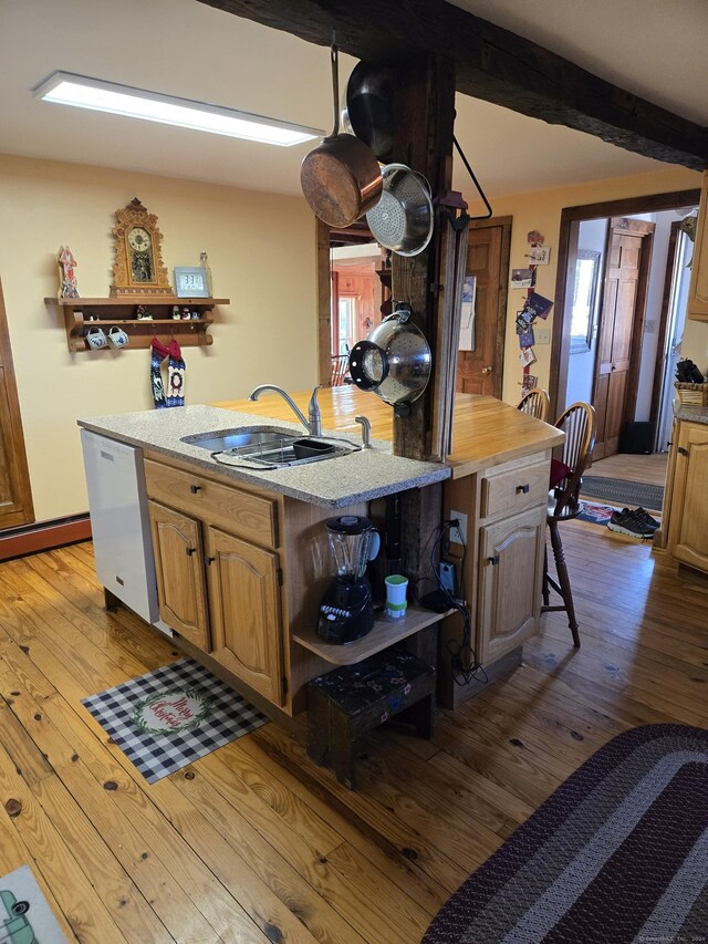 kitchen with dishwasher, a kitchen breakfast bar, light wood-type flooring, and sink