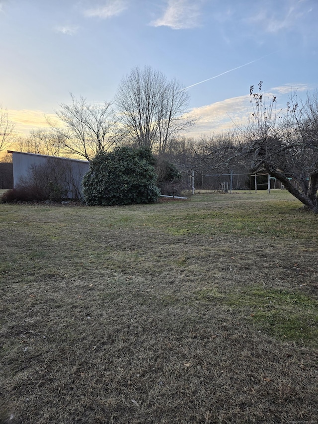 view of yard at dusk