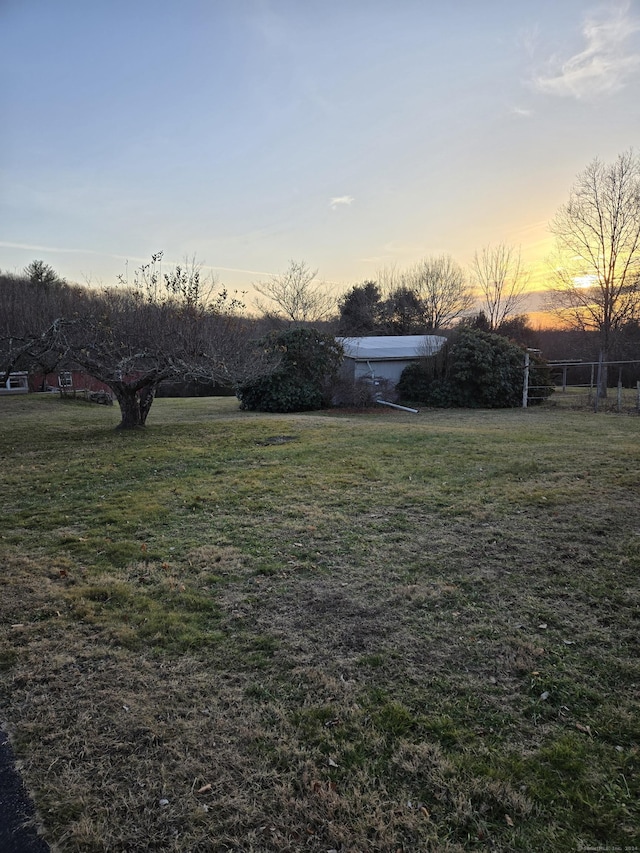 view of yard at dusk