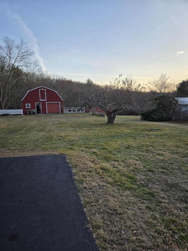 yard at dusk featuring an outbuilding