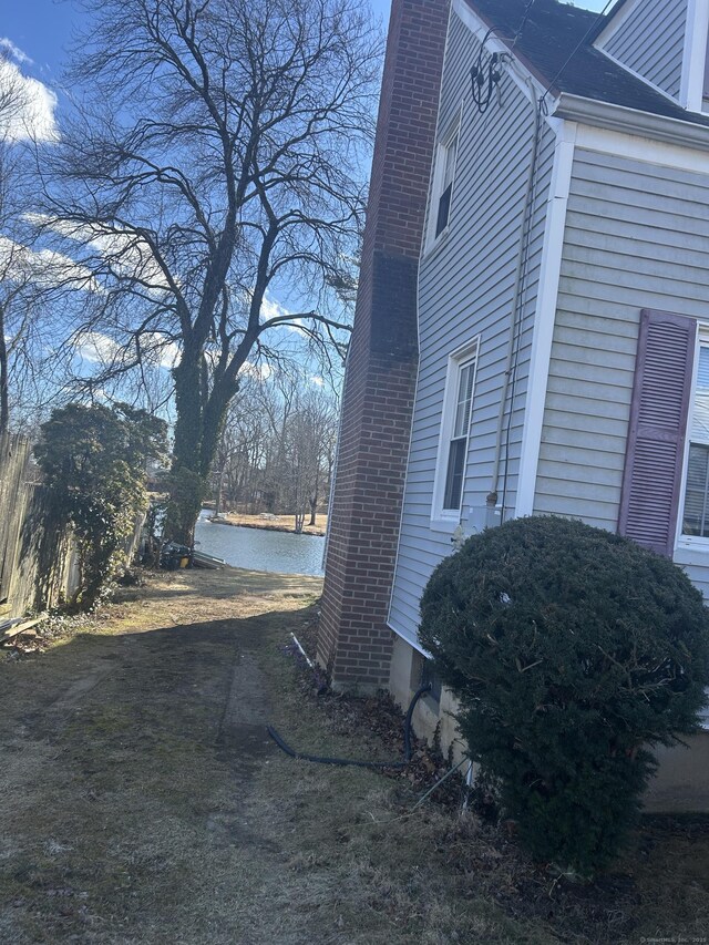 view of property exterior featuring a chimney