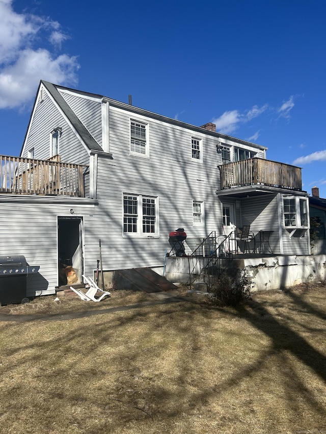 rear view of house featuring a balcony